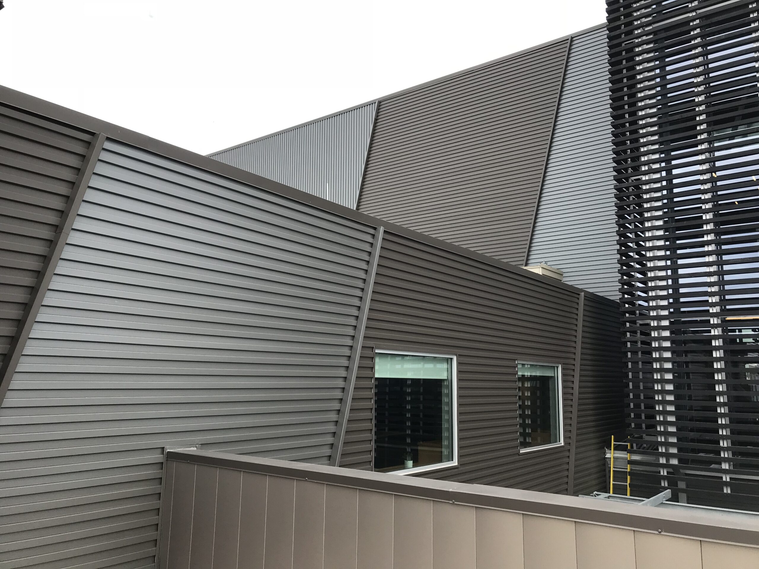 Metal commercial building with concealed fastened metal panels 