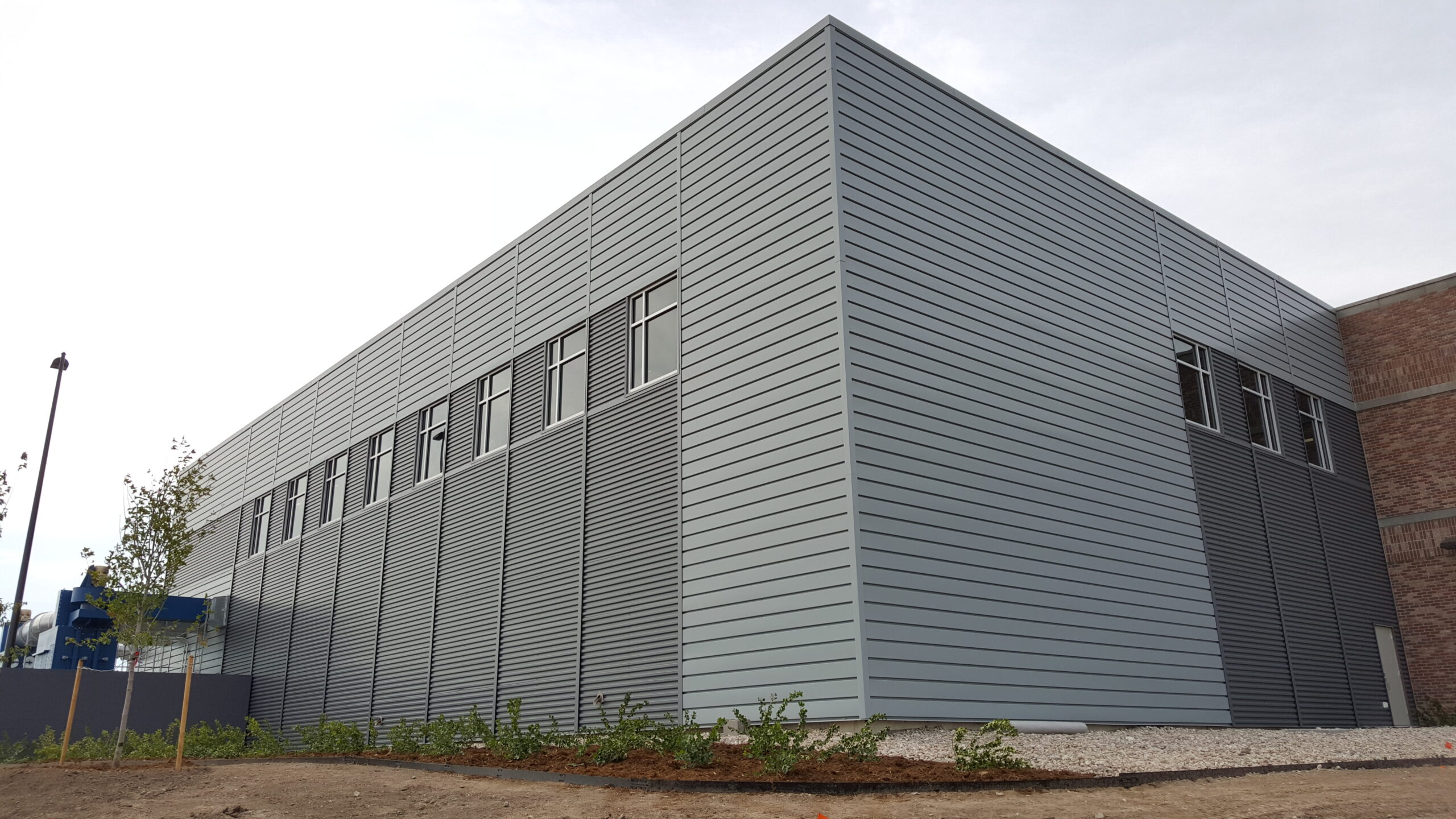Metal commercial building with exposed fastened metal panels 